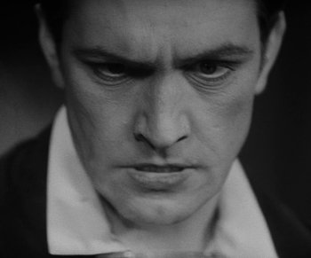 Movie still from “Dr. Jekyll and Mr. Hyde” (1931), directed by Rouben Mamoulian – Black and white photograph of a man's face with a frowning look; Close Up shot, Low angle