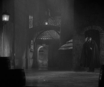 Movie still from “Dr. Jekyll and Mr. Hyde” (1931), directed by Rouben Mamoulian – A man standing in the middle of a room; Wide shot, Low angle