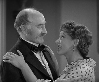 Movie still from “Dr. Jekyll and Mr. Hyde” (1931), directed by Rouben Mamoulian – An older man wearing a suit and tie and a woman wearing a polka dot dress; Medium shot, Over the shoulder angle