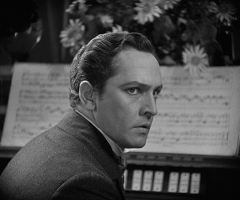 Movie still from “Dr. Jekyll and Mr. Hyde” (1931), directed by Rouben Mamoulian – Black and white photograph of a man in a suit and tie; Close Up shot, Low angle