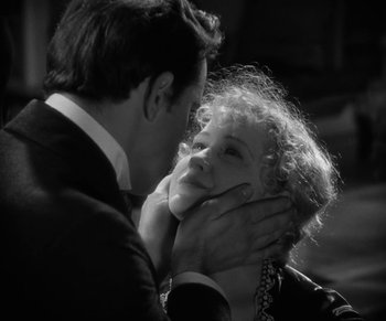 Movie still from “Dr. Jekyll and Mr. Hyde” (1931), directed by Rouben Mamoulian – A man and a woman kissing in a black and white photo; Close Up shot, Over the shoulder angle