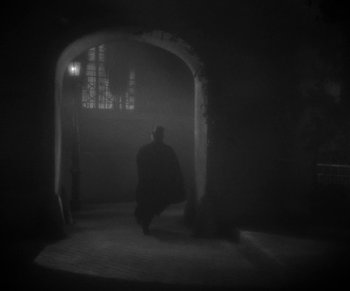 Movie still from “Dr. Jekyll and Mr. Hyde” (1931), directed by Rouben Mamoulian – A man in a black cape walking in a dark room; Wide shot, Low angle