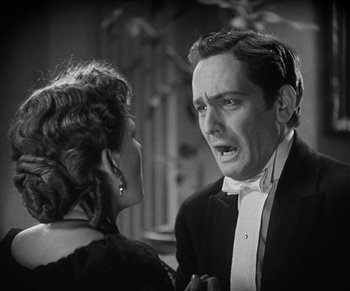 Movie still from “Dr. Jekyll and Mr. Hyde” (1931), directed by Rouben Mamoulian – A man and a woman in formal wear talking to each other; Close Up shot, Over the shoulder angle