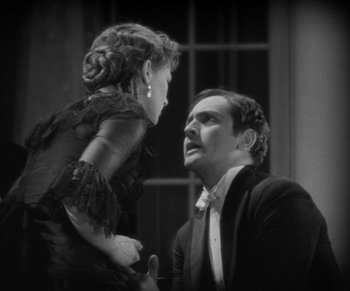 Movie still from “Dr. Jekyll and Mr. Hyde” (1931), directed by Rouben Mamoulian – A man and a woman in a black dress; Medium shot, High angle