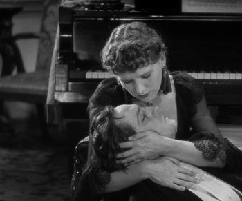 Movie still from “Dr. Jekyll and Mr. Hyde” (1931), directed by Rouben Mamoulian – A woman hugging a woman in front of a grand piano; Close Up shot, High angle