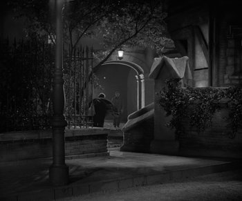 Movie still from “Dr. Jekyll and Mr. Hyde” (1931), directed by Rouben Mamoulian – A person walking down a street at night; Extreme Wide shot, High angle