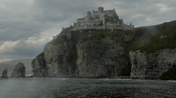 Movie still from “Game of Thrones” (2011), created by D.B. Weiss – A castle on top of a cliff near the ocean; Extreme Wide shot, Low angle