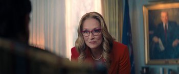 Movie still from “Don't Look Up” (2021), directed by Adam McKay – A person wearing glasses and a red jacket; Close Up shot, Over the shoulder angle