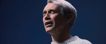 Movie still from “Don't Look Up” (2021), directed by Adam McKay – An older man with a white hair and a white sweater; Close Up shot, Low angle