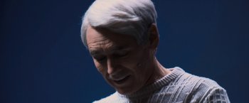 Movie still from “Don't Look Up” (2021), directed by Adam McKay – An older man with white hair is looking down at his face; Close Up shot, High angle