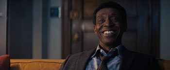 Movie still from “Don't Look Up” (2021), directed by Adam McKay – A man sitting on top of a couch wearing a tie; Close Up shot, Over the shoulder angle