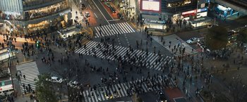 Movie still from “Don't Look Up” (2021), directed by Adam McKay – A large group of people crossing a crosswalk at night; Extreme Wide shot, Overhead angle