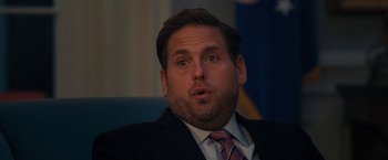 Movie still from “Don't Look Up” (2021), directed by Adam McKay – A person wearing a suit and tie; Close Up shot, Low angle