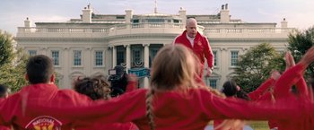 Movie still from “Don't Look Up” (2021), directed by Adam McKay – A group of people standing in front of the white house; Medium shot, Low angle