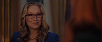 Movie still from “Don't Look Up” (2021), directed by Adam McKay – A person wearing glasses and a suit; Close Up shot, Over the shoulder angle
