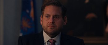 Movie still from “Don't Look Up” (2021), directed by Adam McKay – A person wearing a suit and tie; Close Up shot, Over the shoulder angle
