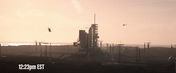 Movie still from “Don't Look Up” (2021), directed by Adam McKay – A very tall building sitting in the middle of a field; Extreme Wide shot, Low angle