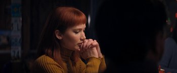 Movie still from “Don't Look Up” (2021), directed by Adam McKay – A woman with red hair is holding her hands in prayer; Close Up shot, High angle