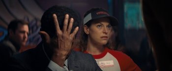 Movie still from “Don't Look Up” (2021), directed by Adam McKay – A woman wearing a baseball cap and a red shirt; Close Up shot, Over the shoulder angle