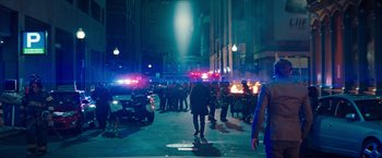 Movie still from “Don't Look Up” (2021), directed by Adam McKay – A group of people walking down a street at night; Extreme Wide shot, Over the shoulder angle