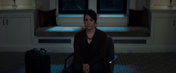 Movie still from “Don't Look Up” (2021), directed by Adam McKay – A woman sitting on a chair in a room; Medium shot, Over the shoulder angle