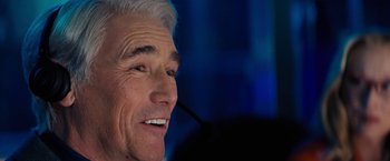 Movie still from “Don't Look Up” (2021), directed by Adam McKay – An older man with white hair is smiling; Close Up shot, Over the shoulder angle