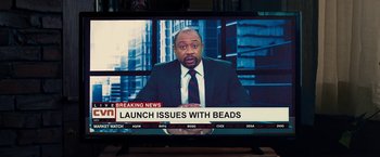 Movie still from “Don't Look Up” (2021), directed by Adam McKay – A man in a suit and tie on a television screen; Extreme Close Up shot, High angle