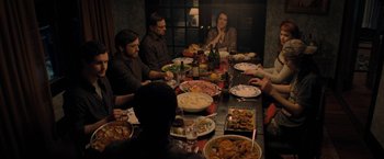 Movie still from “Don't Look Up” (2021), directed by Adam McKay – A group of people sitting at a table with plates of food on it; Medium shot, High angle