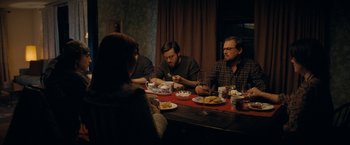 Movie still from “Don't Look Up” (2021), directed by Adam McKay – A group of people sitting at a table eating food; Medium shot, Over the shoulder angle