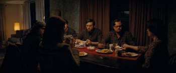 Movie still from “Don't Look Up” (2021), directed by Adam McKay – A group of people sitting at a table with plates of food; Medium shot, Over the shoulder angle