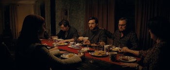 Movie still from “Don't Look Up” (2021), directed by Adam McKay – A group of people sitting around a table eating; Medium shot, High angle