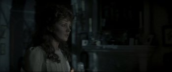 Movie still from “Dracula” (1979), directed by John Badham – A woman in a white dress standing in a dark room; Close Up shot, Over the shoulder angle