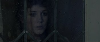 Movie still from “Dracula” (1979), directed by John Badham – A woman looking out of a window at night; Close Up shot, High angle