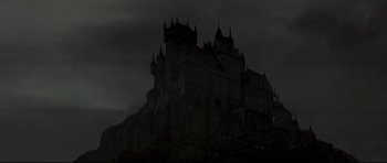 Movie still from “Dracula” (1979), directed by John Badham – A dark picture of a castle in the dark; Extreme Wide shot, Low angle