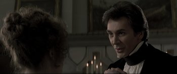 Movie still from “Dracula” (1979), directed by John Badham – A man in a black shirt and a woman in a white dress; Close Up shot, Over the shoulder angle