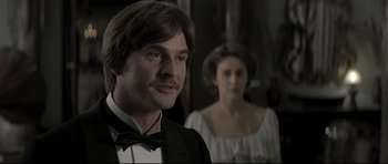 Movie still from “Dracula” (1979), directed by John Badham – A man and a woman standing next to each other; Close Up shot, Over the shoulder angle