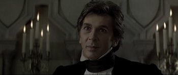 Movie still from “Dracula” (1979), directed by John Badham – A person wearing a suit and tie; Close Up shot, Low angle