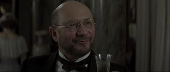 Movie still from “Dracula” (1979), directed by John Badham – An older man wearing a suit and bow tie; Close Up shot, Low angle