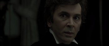 Movie still from “Dracula” (1979), directed by John Badham – A person wearing a suit and tie; Close Up shot, Over the shoulder angle