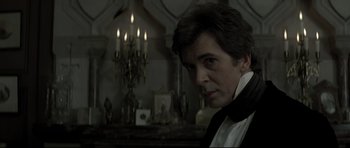 Movie still from “Dracula” (1979), directed by John Badham – A person in a room with candles; Close Up shot, Over the shoulder angle