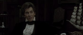 Movie still from “Dracula” (1979), directed by John Badham – A person wearing a suit and tie; Medium shot, Over the shoulder angle