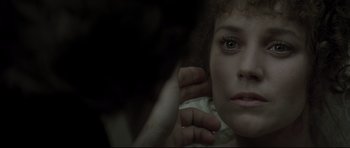 Movie still from “Dracula” (1979), directed by John Badham – A woman is holding her hair in front of her face; Close Up shot, Over the shoulder angle