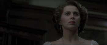 Movie still from “Dracula” (1979), directed by John Badham – A woman looking up into the air with a necklace hanging from her neck; Close Up shot, Over the shoulder angle