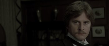 Movie still from “Dracula” (1979), directed by John Badham – A person wearing a suit and tie; Close Up shot, Over the shoulder angle