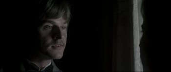 Movie still from “Dracula” (1979), directed by John Badham – A person wearing a suit and tie; Close Up shot, Over the shoulder angle