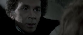Movie still from “Dracula” (1979), directed by John Badham – A man's face in the dark; Close Up shot, Over the shoulder angle