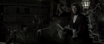 Movie still from “Dracula” (1979), directed by John Badham – A woman standing next to an animal in a dark room; Medium shot, Low angle