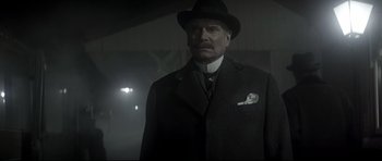 Movie still from “Dracula” (1979), directed by John Badham – An older man in a suit and a hat; Medium shot, Low angle