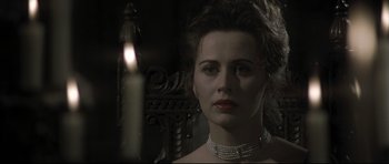 Movie still from “Dracula” (1979), directed by John Badham – A person wearing a necklace; Close Up shot, Over the shoulder angle