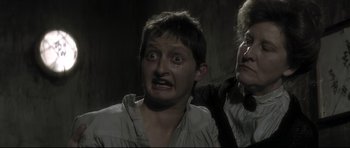 Movie still from “Dracula” (1979), directed by John Badham – A man is crying while a woman looks at him; Close Up shot, Over the shoulder angle